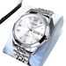 Montre à quartz pour homme, de couleur argentée, avec lunette multifacettes, index en diamants et affichage de la date et du jour.